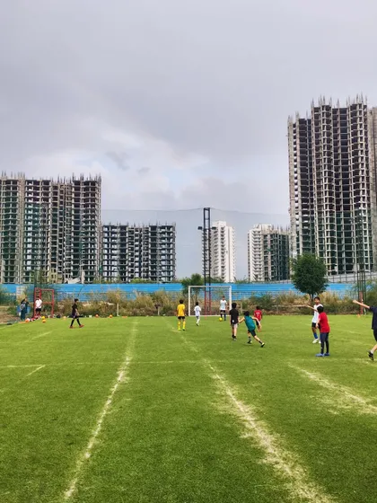 Another view of our training game, with players spread out across the natural grass pitch.