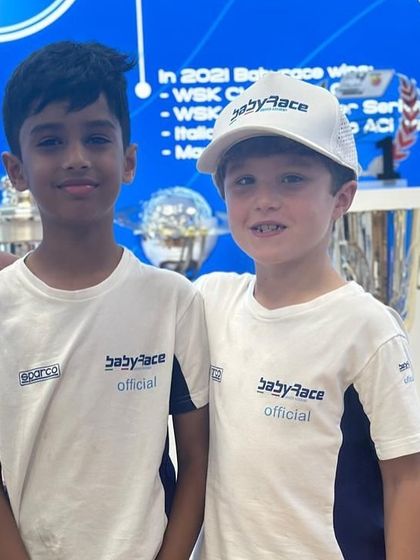 Our young driver making friends with a fellow international competitor at the Baby Race Academy.