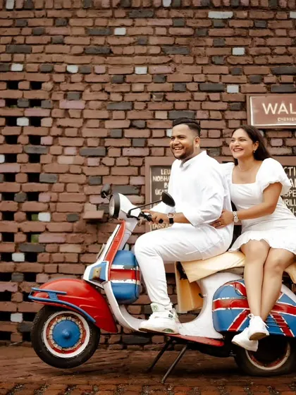 A fun and retro vibe with a classic scooter against a rustic brick wall. This pre-wedding shot is perfect for couples looking for a unique and stylish theme.