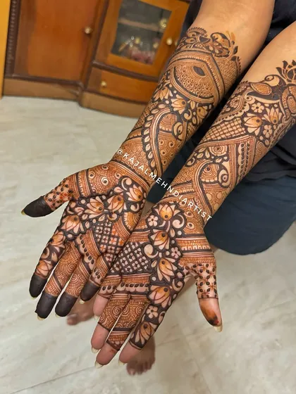 A stunning engagement bridal henna design that is both dense and delicate, featuring peacocks and lotuses.