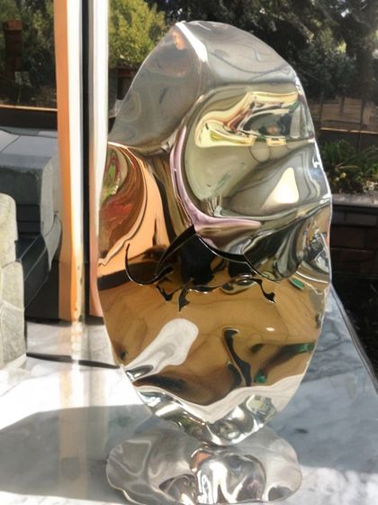 From my Bull Series, this freestanding sculpture features a bull engraving on a fluidly shaped piece of polished steel, symbolizing power and persistence.