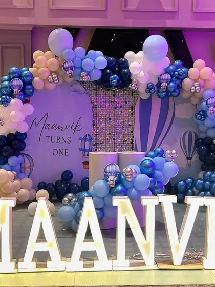 A closer look at the main stage for Maanvik's party, showing the detailed balloon arch and custom backdrop.