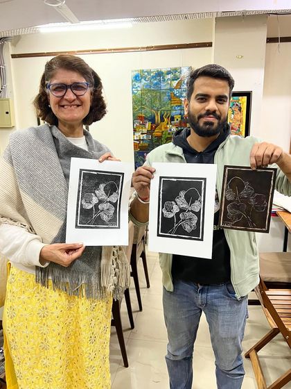 Our instructor and a student showcasing her beautiful floral linocut print alongside the original carved block.