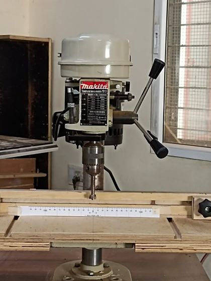 The finished drill press table, complete with a fence and zero-center scales for easy alignment. This simple shop-made jig greatly improves the tool's accuracy.