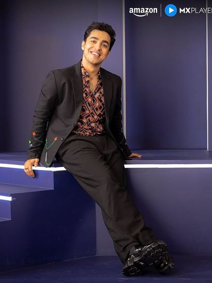 Gagan Arora posing for Amazon MX Player promotions in the full outfit I styled, featuring a unique embroidered blazer and patterned shirt.