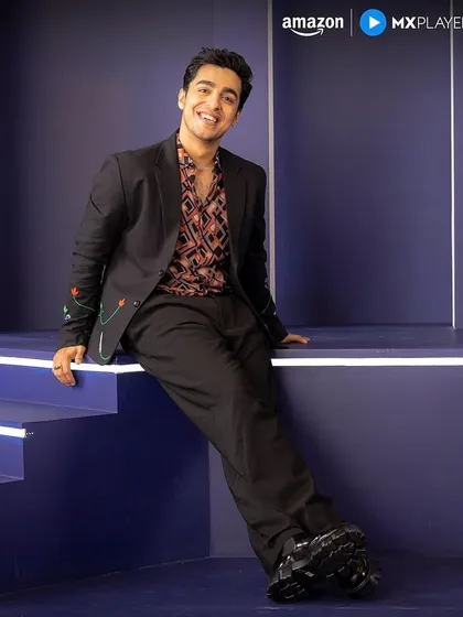 Gagan Arora posing for Amazon MX Player promotions in the full outfit I styled, featuring a unique embroidered blazer and patterned shirt.