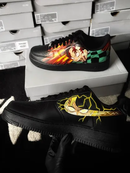 The inner swooshes of the Demon Slayer custom sneakers, featuring detailed character portraits of Zenitsu and Tanjiro.