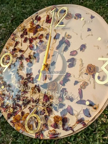 A different angle of the 12-inch floral wall clock, showing how the light reflects off the glossy resin surface.