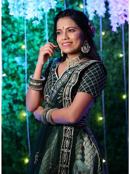 This client looks elegant in a dark green lehenga with beautiful gold embroidery. The matching jewellery and bangles complete this classic and festive look.