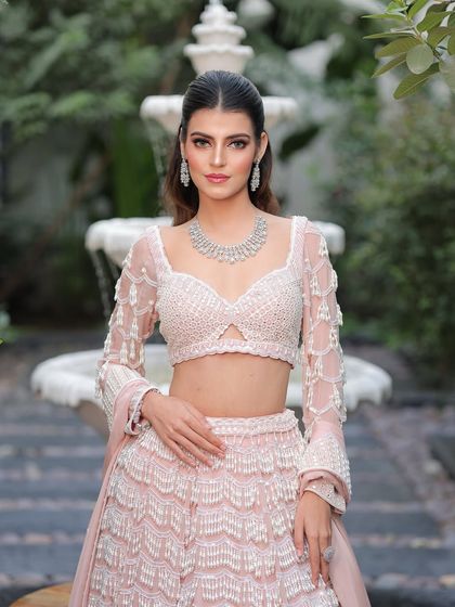 A confident and poised bride. The makeup is fresh and modern, perfect for a daytime wedding or an elegant evening reception.