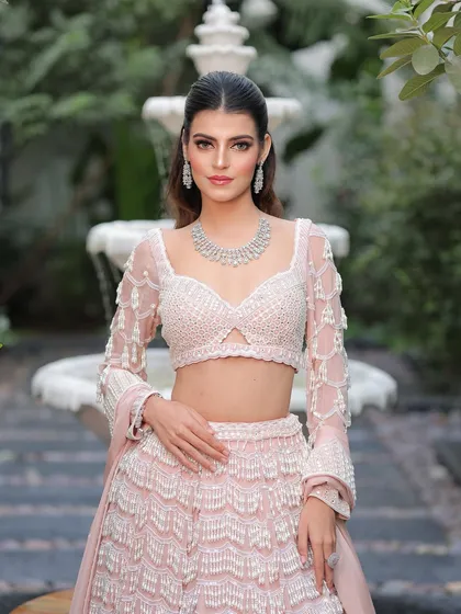 A confident and poised bride. The makeup is fresh and modern, perfect for a daytime wedding or an elegant evening reception.
