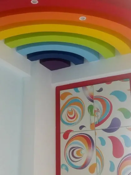A fun and colorful rainbow themed false ceiling design we created for a kids' room in Indirapuram.