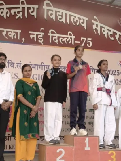 Aliya on the winner's podium, taking the first-place spot at the PM Shree Kendriya Vidyalaya Regional Taekwondo Championship.