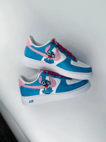 A pair of custom Nike Air Force 1s featuring the adorable alien Stitch from Disney's Lilo & Stitch.