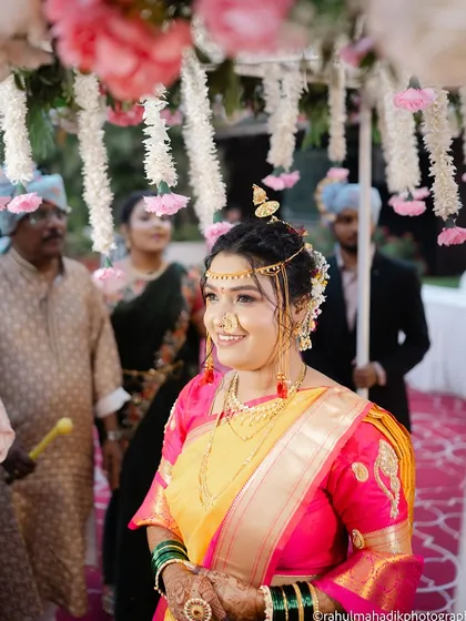 The bride's happy face as she walks under the floral canopy.