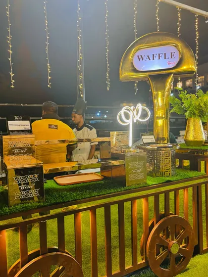 The waffle station, elegantly lit with fairy lights, ready for an evening event.