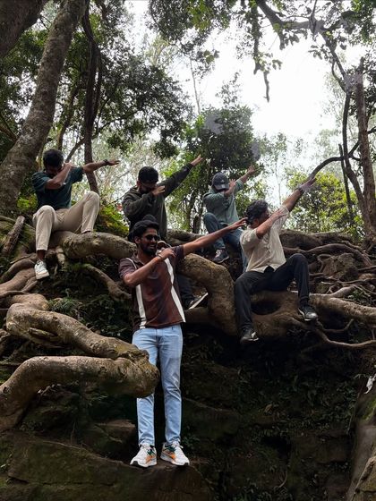 A group of guys striking a pose on the giant roots of a tree in Kodaikanal.
