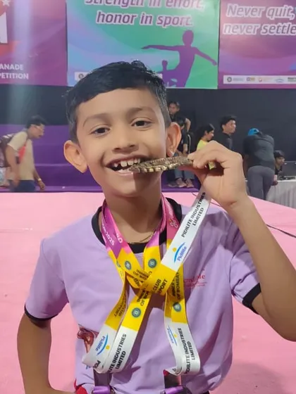 This smile says it all. The joy of achievement after months of discipline and practice is priceless. We don't just train gymnasts; we build champions who wear their hard-earned medals with pride.