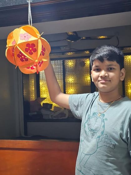 This young man is happy with his handcrafted Diwali lantern. We teach kids how to construct and decorate their own unique lanterns.