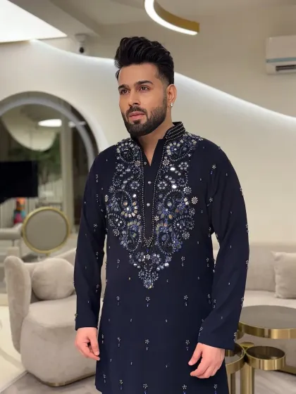 Side profile showing the fit and detail of the navy kurta.