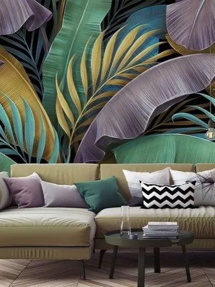 A bold and modern take on tropical design, this wallpaper features large leaves in shades of purple, teal, and gold against a black background.