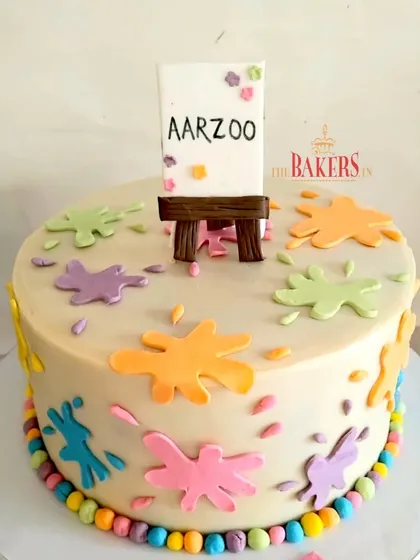 An art-themed cake for Aarzoo, with creative splashes of color and a tiny easel. This minimal-fondant cake is perfect for anyone who loves to paint and create.