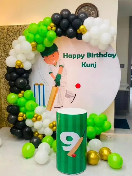 For the little cricket fan, I can create a cricket-themed birthday party. This setup includes a custom backdrop and a balloon arch in team colors.