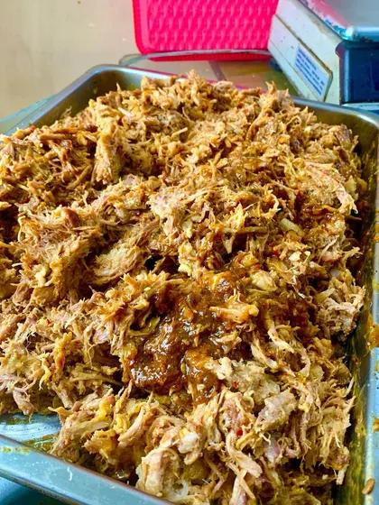 A generous tray of our signature Pulled Pork, slow-cooked for eight hours until it's perfectly tender. We then toss it in a rich, tangy tomato and BBQ reduction made from its own flavorful juices.
