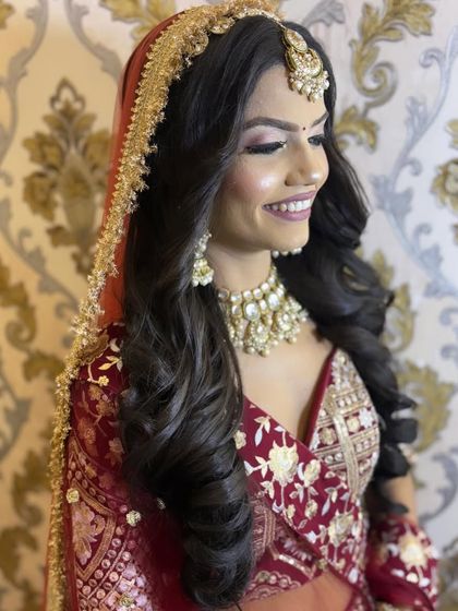 A happy and bright portrait from a styled shoot. The model's smile and the soft, glamorous makeup create a look that is both aspirational and beautiful.
