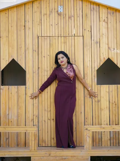 A confident pose against the wooden cabin set. We offer a variety of backdrops to match your personal style.