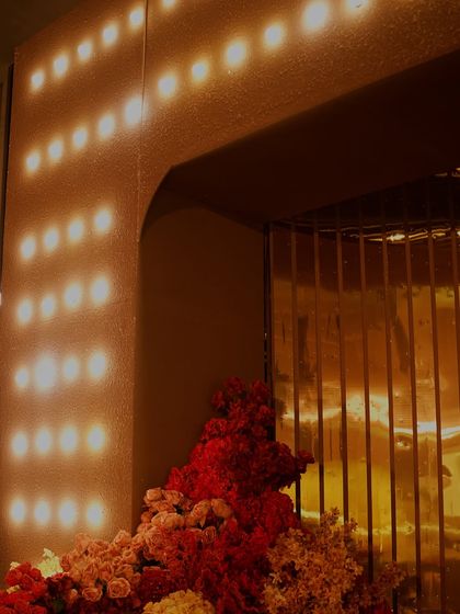 A detail of the moody lighting and rich red florals from a glamorous Sangeet night.