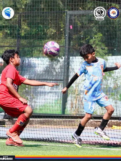 A player brings the ball down with a deft touch. First touch and control are skills we emphasize from a young age.