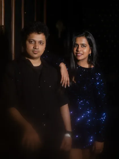 A cool, posed shot of the couple. The low-key lighting and their confident expressions give this photo a modern, stylish vibe.