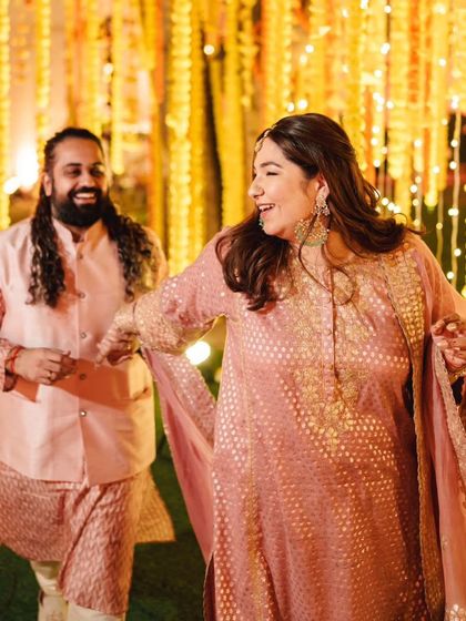A candid moment of celebration. Shubhi dances with her partner, her Aulerth jewelry moving with her. It's a testament to finding pieces that are not just beautiful but also comfortable enough for celebration.