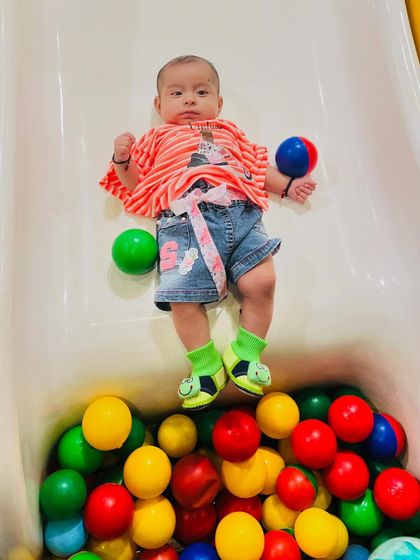 Another angle of this tiny tot enjoying her slide adventure. Safety and fun go hand in hand here.