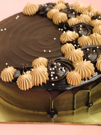 This is our signature best-selling chocolate cake, a guaranteed crowd-pleaser for any celebration. It features layers of moist, eggless chocolate sponge and rich ganache, decorated with elegant piping.