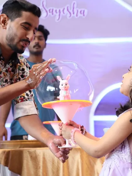 A bubble artist creates a magical moment by putting the birthday girl inside a giant bubble. It's a unique entertainment option that kids absolutely love.