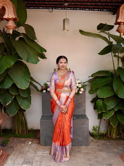 A full view of the engagement ensemble, showcasing the elegant drape of the silk saree against a backdrop of lush greenery. This is a look crafted for the bride who desires elegance with a modern flair.