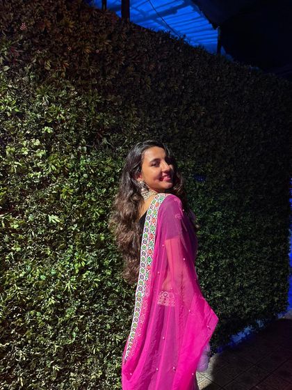 A happy client enjoying her Navratri night in a comfortable and stylish rental outfit.