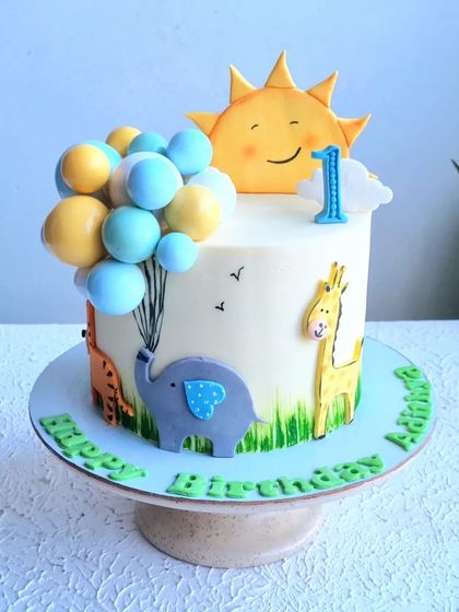A full view of the sunny-themed first birthday cake.