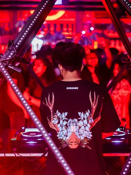 A shot from behind, showing off the cool graphic on my t-shirt while I mix for the crowd at The Fixx Bar.