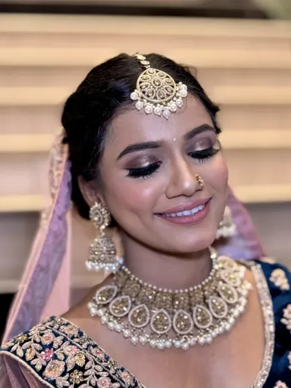 A close-up of a soft and romantic bridal look. The shimmering eyeshadow, defined lashes, and perfect pink lip come together for a timeless and elegant feel.
