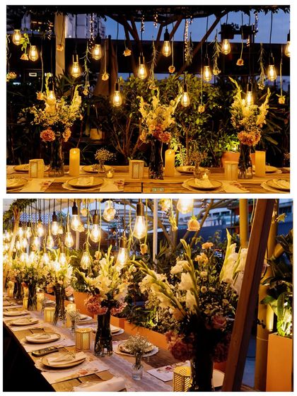 Another perspective on the elegant table setting, showcasing the interplay of light from the hanging bulbs with the fresh floral centerpieces. Every element is carefully chosen to enhance the overall aesthetic.
