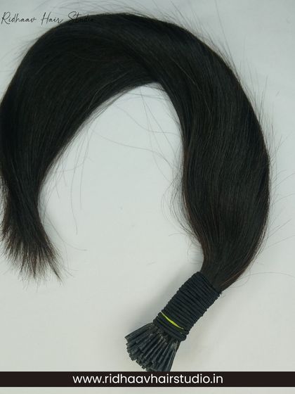 A bundle of our I-Tip single-drawn wavy hair extensions, showcasing their natural wave and the quality of the 100% human hair.