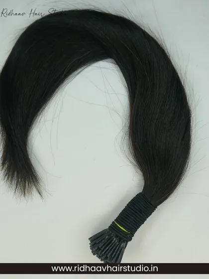 A bundle of our I-Tip single-drawn wavy hair extensions, showcasing their natural wave and the quality of the 100% human hair.