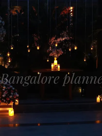 I specialize in creating magical, once-in-a-lifetime moments. This romantic outdoor dinner setup features hanging lights and candles for an unforgettable evening under the stars.