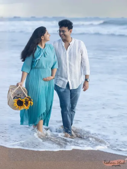 A gentle stroll along the shore during the magical golden hour. This beach maternity session captures the relaxed and joyful connection between the couple, with a basket of sunflowers adding a perfect pop of color.