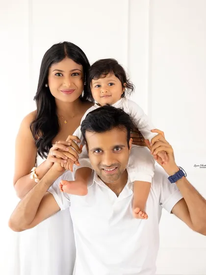 The classic family portrait, reimagined. We guide you into comfortable, natural poses that let your family's love shine through, creating timeless images against a clean, minimalist backdrop. This is a perfect example of our natural light family sessions.