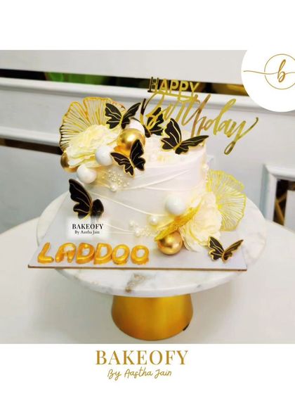 Golden elegance for a special day. This luxurious gold and black butterfly-themed cake is the perfect blend of beauty and sweetness.