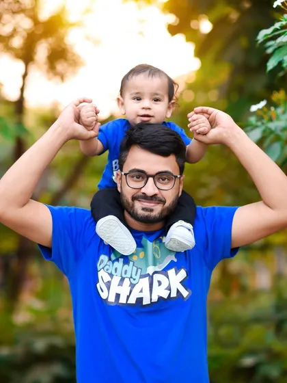 A beautiful close-up of a father and his son, both smiling for the camera. These father-son moments are truly special.